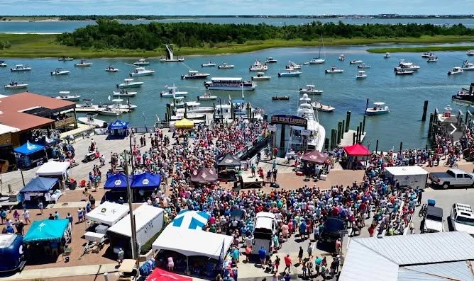 Large coastal community event viewed from above