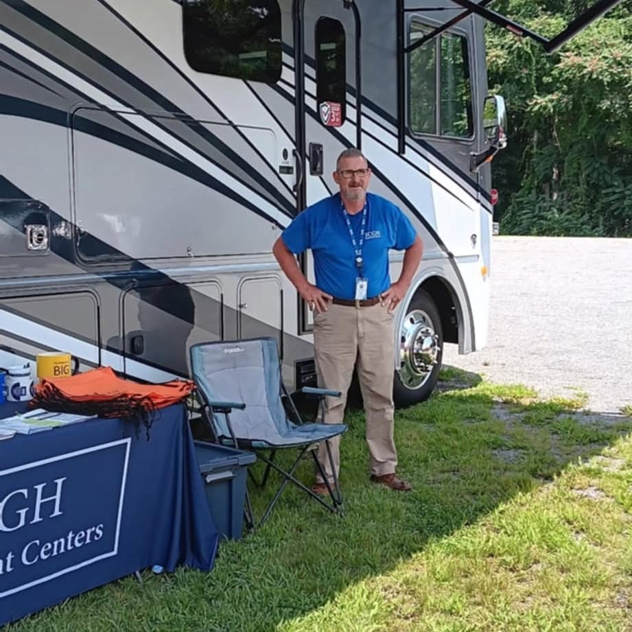 ICGH staff member at a mobile outreach table