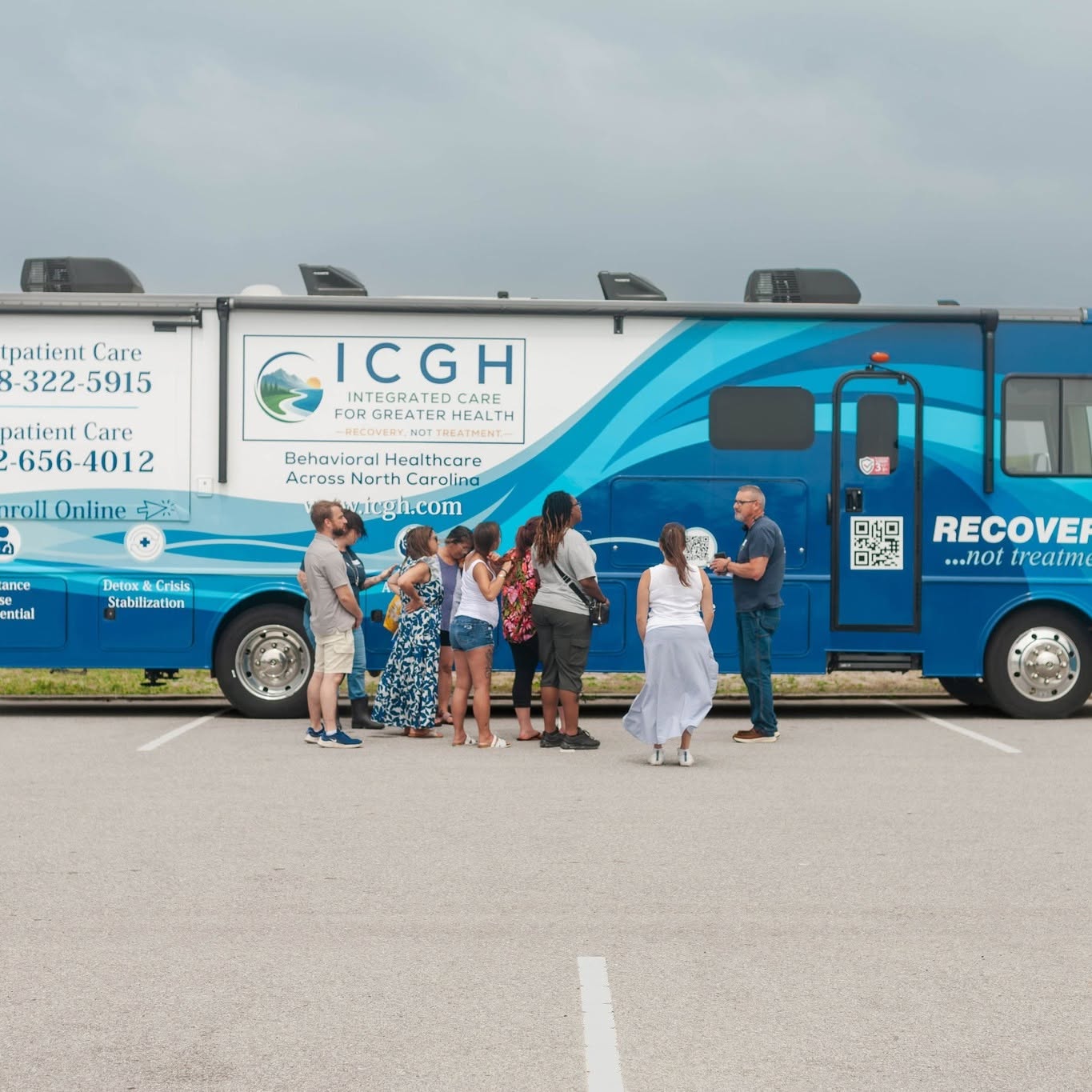 Community members gathered beside the ICGH mobile unit